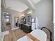 This bathroom features a soaking tub, dark vanity, hardwood floors, and an arched doorway at 15024 Eaglepark Pl, Lithia, FL 33547