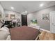 Cozy bedroom with a brown comforter, ceiling fan, and laminate flooring at 15024 Eaglepark Pl, Lithia, FL 33547