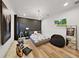 Modern bedroom with a gray accent wall, stylish decor, and light wood flooring at 15024 Eaglepark Pl, Lithia, FL 33547
