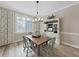 Light and bright dining room featuring a wooden table, cottage style cabinet, and natural light at 15024 Eaglepark Pl, Lithia, FL 33547