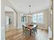 Elegant dining room features a wooden table set, chandelier, and large window with shutter-style blinds at 15024 Eaglepark Pl, Lithia, FL 33547