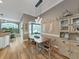 Open dining area with rustic table, decor, and view to the outdoor patio and pool at 15024 Eaglepark Pl, Lithia, FL 33547