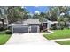 Lovely home with a large manicured front lawn, attached garage, and a picturesque entrance at 15024 Eaglepark Pl, Lithia, FL 33547