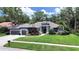 Charming single-story home with an attached garage, lush front lawn, and inviting entrance at 15024 Eaglepark Pl, Lithia, FL 33547