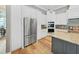 Kitchen with an island, stainless refrigerator, built-in microwave, and white cabinetry at 15024 Eaglepark Pl, Lithia, FL 33547
