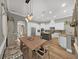 Bright kitchen featuring white cabinets, a gray island, stainless appliances, and hardwood floors at 15024 Eaglepark Pl, Lithia, FL 33547
