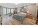 This main bedroom has hardwood floors, recessed lighting, and a bay window with shutters at 15024 Eaglepark Pl, Lithia, FL 33547