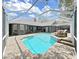 Outdoor covered pool surrounded by lush backyard and home at 15024 Eaglepark Pl, Lithia, FL 33547