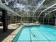 Screened-in pool features ample brick decking and tile accents with two lounge chairs at 15024 Eaglepark Pl, Lithia, FL 33547
