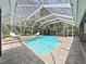Sparkling pool inside screen enclosure features lounge seating and landscaped surroundings at 15024 Eaglepark Pl, Lithia, FL 33547