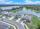 Aerial view of homes near a tranquil lake, showcasing curb appeal and neighborhood charm at 1655 Blue Rose Dr, Ruskin, FL 33570