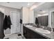 Bathroom featuring a double vanity with granite countertop and tiled floors at 1655 Blue Rose Dr, Ruskin, FL 33570
