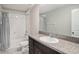 Well-lit bathroom featuring a vanity with granite countertop, a toilet, and a shower-tub with tile surround at 1655 Blue Rose Dr, Ruskin, FL 33570