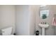 Neutral powder room featuring pedestal sink with oval mirror and tile flooring at 1655 Blue Rose Dr, Ruskin, FL 33570