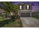 Charming two-story home featuring a well-maintained lawn and an attached two-car garage at 1655 Blue Rose Dr, Ruskin, FL 33570