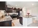 Modern kitchen with granite countertops, stainless steel appliances, and a large island at 1655 Blue Rose Dr, Ruskin, FL 33570