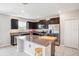 Stylish kitchen with stainless steel appliances, island, and dark cabinets at 1655 Blue Rose Dr, Ruskin, FL 33570