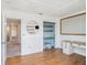 Bright home office with custom desk, hardwood floors, and storage at 1655 Blue Rose Dr, Ruskin, FL 33570