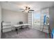 Office with carpet, a long desk, rolling chair, shelving, and a bright window at 1655 Blue Rose Dr, Ruskin, FL 33570