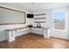 Bright home office with custom desk, hardwood floors, and ample storage space at 1655 Blue Rose Dr, Ruskin, FL 33570