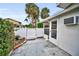 Private backyard features a paved patio, privacy fence, and lush tropical landscaping at 1660 Cape Ann Ne Ave # 2, St Petersburg, FL 33702