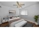 Cozy bedroom features a ceiling fan and a comfortable bed with stylish decor at 1660 Cape Ann Ne Ave # 2, St Petersburg, FL 33702