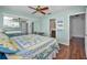 Bright main bedroom featuring an accent wall, ceiling fan and mirrored closet at 1660 Cape Ann Ne Ave # 2, St Petersburg, FL 33702