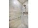 Luxurious shower with marble tile surround and convenient built-in niche for toiletries at 1660 Cape Ann Ne Ave # 2, St Petersburg, FL 33702