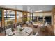 Sunroom with wood-look floors, lots of windows, dining and seating areas offering backyard views at 1660 Cape Ann Ne Ave # 2, St Petersburg, FL 33702