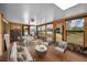 Bright sunroom with wood-look floors, lots of windows, dining and seating areas offering backyard views at 1660 Cape Ann Ne Ave # 2, St Petersburg, FL 33702