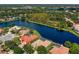A high-angle view features homes with swimming pools along the picturesque lake at 17921 Arbor Haven Dr, Tampa, FL 33647