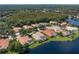 Aerial view highlighting waterfront homes along a lake, amidst lush greenery and mature trees at 17921 Arbor Haven Dr, Tampa, FL 33647