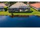Aerial view of a home with a large screened patio, a gorgeous pool, and a peaceful water view at 17921 Arbor Haven Dr, Tampa, FL 33647