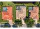 Directly above view showcasing three residences, highlighting their pristine pools and meticulously kept yards at 17921 Arbor Haven Dr, Tampa, FL 33647