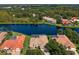 Aerial view featuring beautiful homes around a large lake with green trees at 17921 Arbor Haven Dr, Tampa, FL 33647