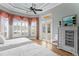 Airy bedroom with dual beds, shuttered windows, and an outdoor view, providing a tranquil retreat with plenty of natural light at 17921 Arbor Haven Dr, Tampa, FL 33647