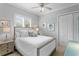 Bright bedroom featuring neutral colored walls, shutters, and ceiling fan at 17921 Arbor Haven Dr, Tampa, FL 33647
