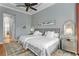 Bright bedroom featuring two beds, soft blue walls, and a stylish ceiling fan at 17921 Arbor Haven Dr, Tampa, FL 33647