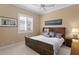 Bedroom with modern decor featuring dark wood furniture and a bright window at 17921 Arbor Haven Dr, Tampa, FL 33647