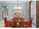 Formal dining room with wood table, stylish chandelier, and large window at 17921 Arbor Haven Dr, Tampa, FL 33647