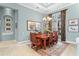 Elegant dining room with wood table, decorative rug, and chandelier lighting, creating a refined ambiance for Gathering and guests at 17921 Arbor Haven Dr, Tampa, FL 33647