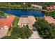 Aerial view showcasing the home's exterior, landscaping, and beautiful lake view at 17921 Arbor Haven Dr, Tampa, FL 33647