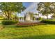 Beautiful community fountain surrounded by manicured lawn and colorful flowers at 17921 Arbor Haven Dr, Tampa, FL 33647