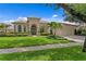 Inviting front exterior of home featuring manicured landscaping, a driveway, and an attached garage at 17921 Arbor Haven Dr, Tampa, FL 33647