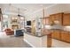 Spacious kitchen with a granite island, wood cabinetry, and an open layout that connects to the living area and fireplace at 17921 Arbor Haven Dr, Tampa, FL 33647