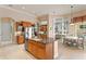 Open kitchen featuring a center island, wood cabinets, and seamless flow to the dining and living areas for easy entertaining at 17921 Arbor Haven Dr, Tampa, FL 33647