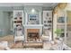 Stylish living room with fireplace, shelving, and a view of the outdoor living area at 17921 Arbor Haven Dr, Tampa, FL 33647