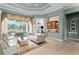 Bright living room with tile flooring, neutral sofa, and screened patio access at 17921 Arbor Haven Dr, Tampa, FL 33647