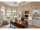 Well-appointed office with custom built-ins, large windows, and a stylish desk for an inspiring and productive workspace at 17921 Arbor Haven Dr, Tampa, FL 33647