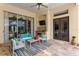 Covered outdoor patio featuring tile floors, comfortable seating, and views of the lanai and backyard at 17921 Arbor Haven Dr, Tampa, FL 33647